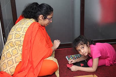 A therapist with a young girl during a listening session